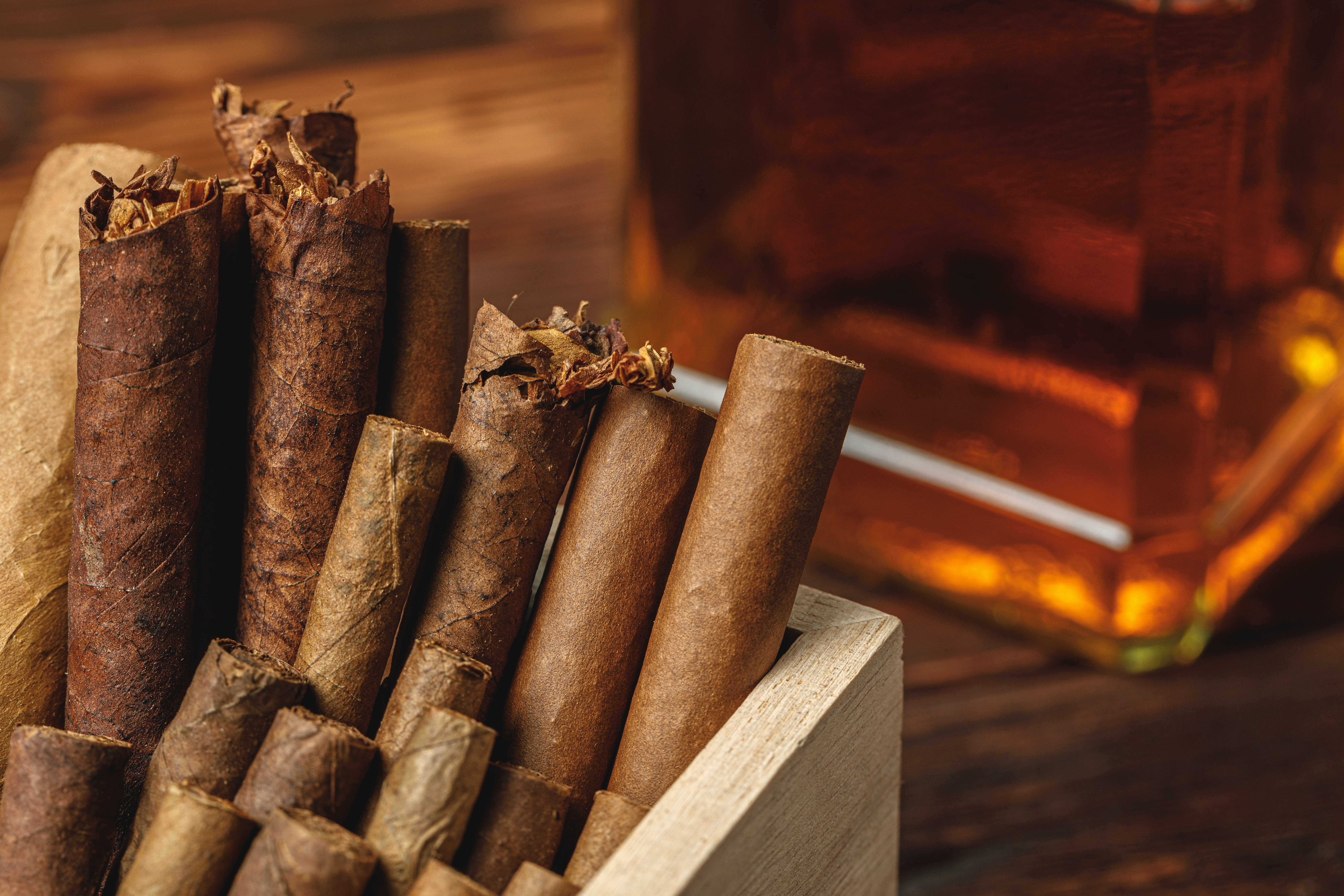 pile-new-cuban-cigars-near-bottle-alcohol